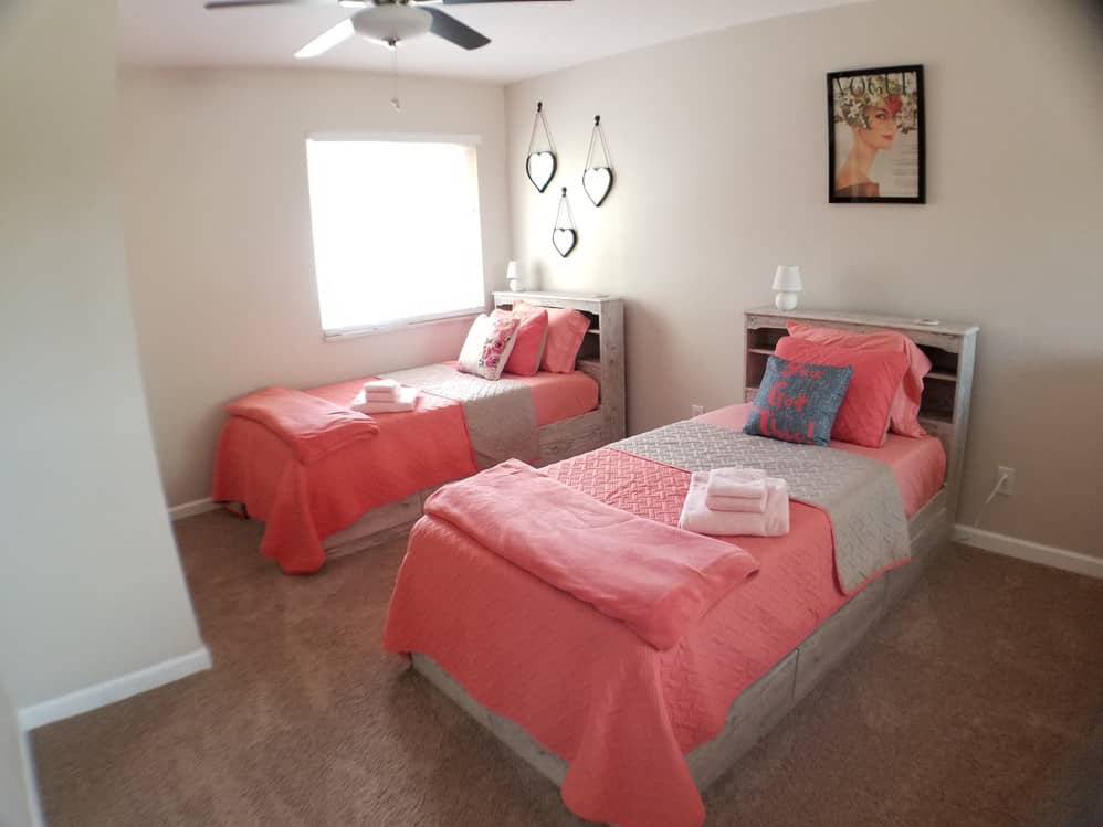 two single beds with pink matresses and pillows