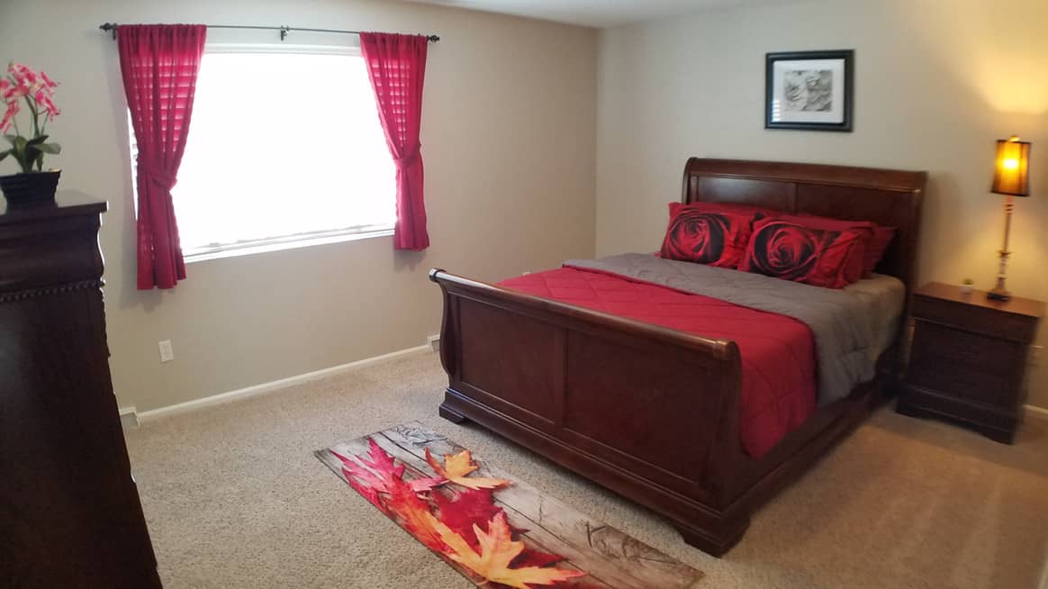 one large bed with red mattresses and pillows
