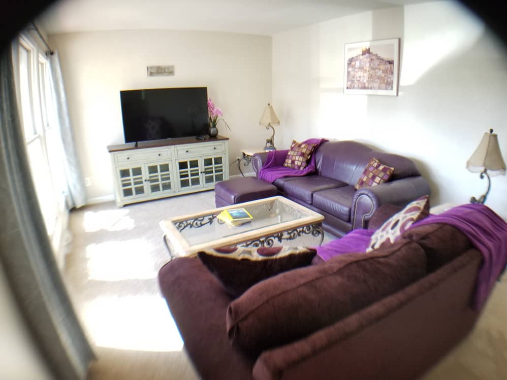 living room with purple sofas and flat screen TV