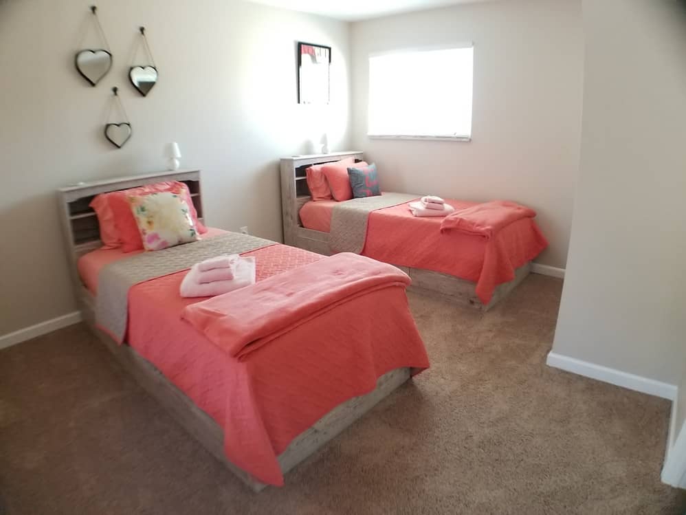 two single beds with pink matresses and pillows